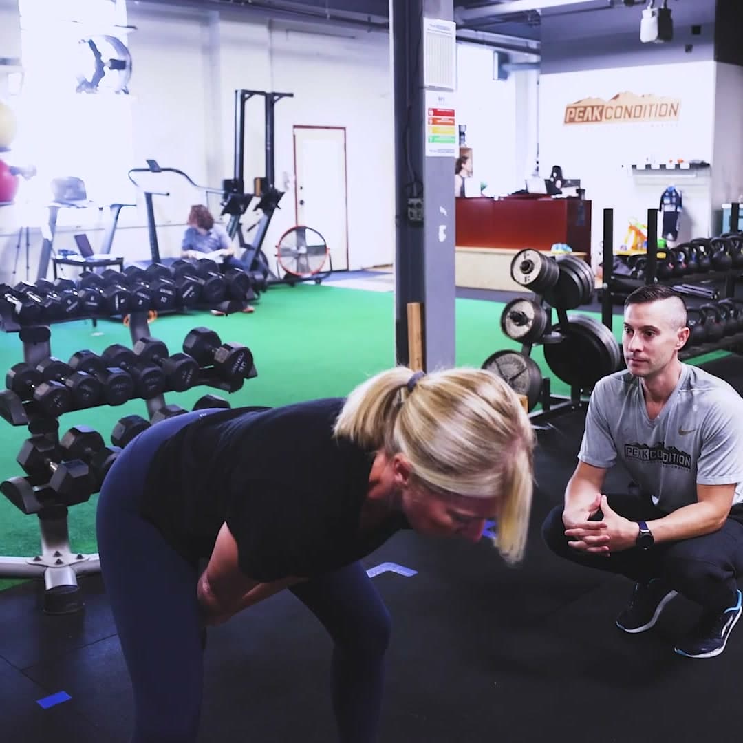 Paul Collins coaching an athlete through a position at Peak Condition